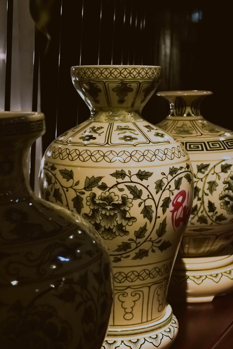 A collection of intricately designed Asian ceramic vases showcasing floral patterns and artisan craftsmanship.