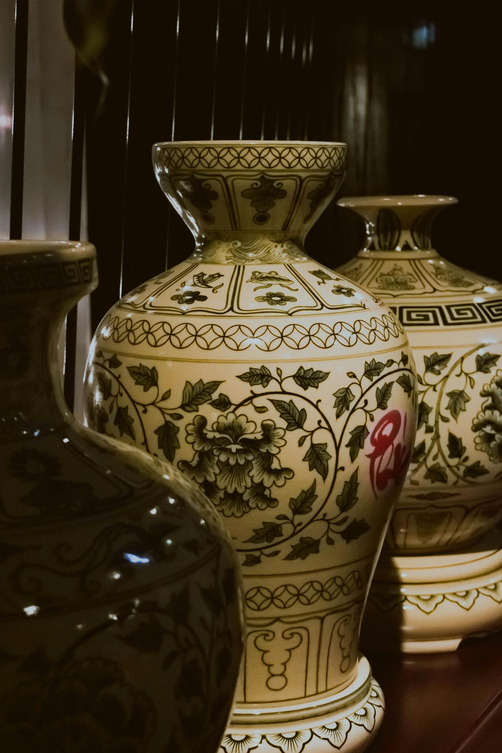 A collection of intricately designed Asian ceramic vases showcasing floral patterns and artisan craftsmanship.